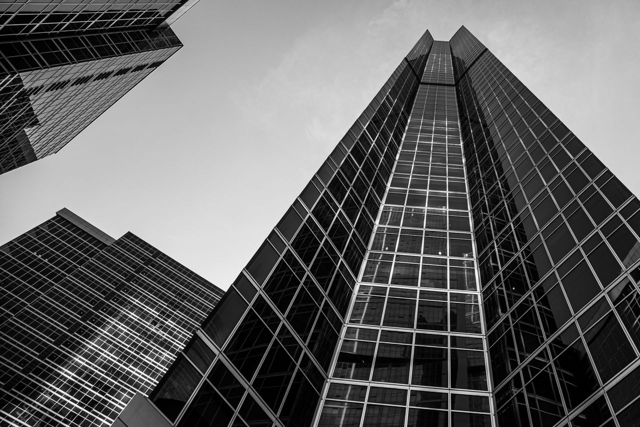 Striking black and white angle of modern skyscrapers, showcasing urban architecture.